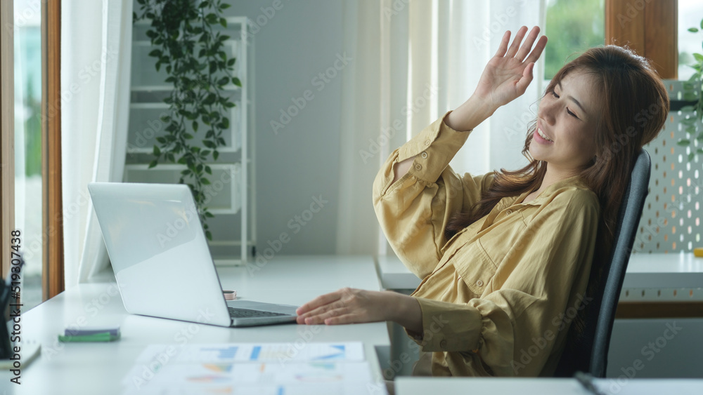 Cheerful working woman waving hand, chatting online, making video call on laptop computer. Cheerful working woman waving hand, chatting online, making video call on laptop computer.