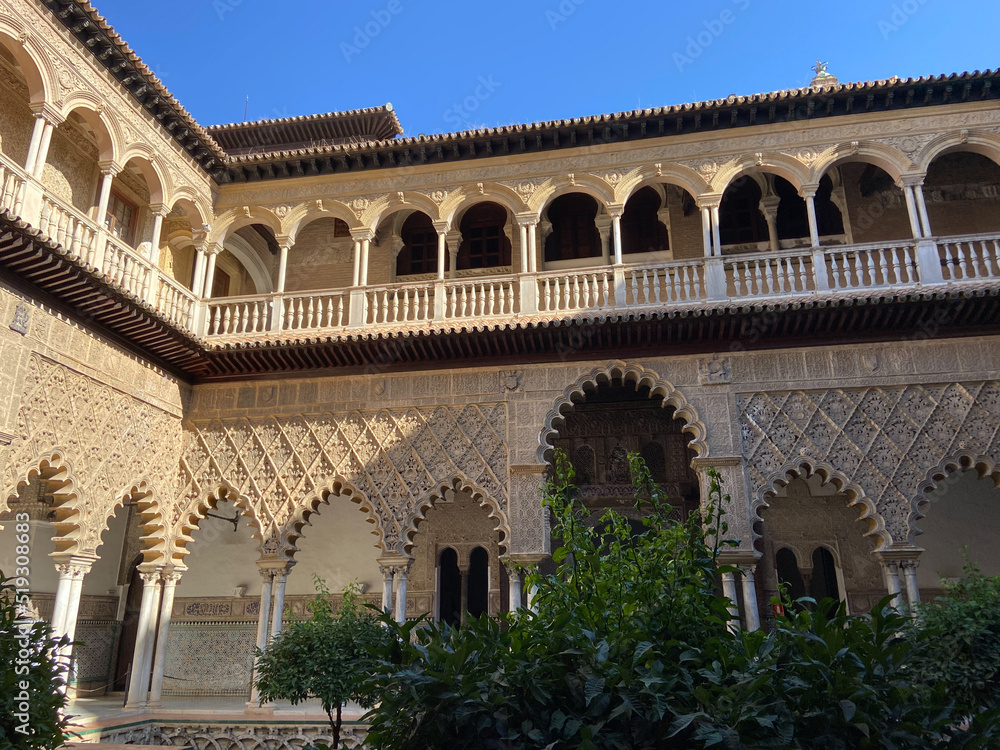 Seville, Spain, September 12, 2021: Royal Palace of Seville (Real Alcazar). The Maidens Courtyard. The Mudejar of Pedro I on the ground floor and the Renaissance of the first monarchs.