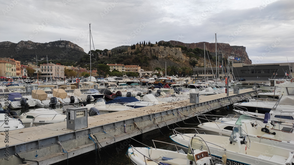 Cassis, France, October 5, 2021: The Marina of Cassis. Cassis marina is also a fishing and trading port. Traditional houses, restaurant terraces and boats docked at the port of Cassis.