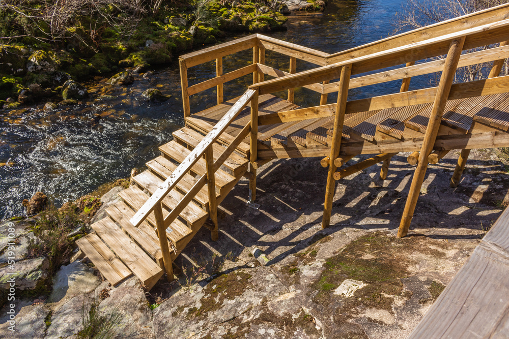 The river hiking trail Ecovia do Vez near Arcos de Valdevez, Portugal. Ecovia do Vez wooden pathways along the riverside. The river hiking trail Ecovia do Vez near Arcos de Valdevez, Portugal. Ecovia do Vez wooden pathways along the riverside.