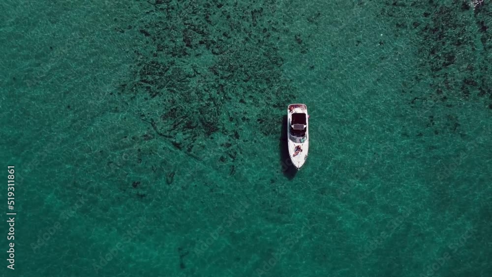 Drone shot of a boat anchored on the open sea. Top down shot from bird's-eye view. Drone shot of a boat anchored on the open sea. Top down shot from bird's-eye view.