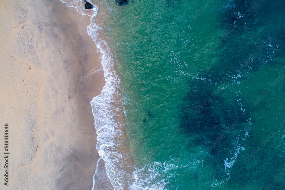 AERIAL VIEW OF A EMPTY BEACH WITH TURQUOISE WATERS