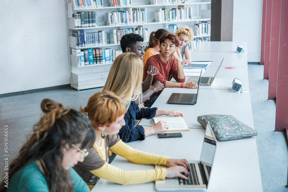 Group of college students studying at university - focus on young asian man Group of college students studying at university - focus on young asian man