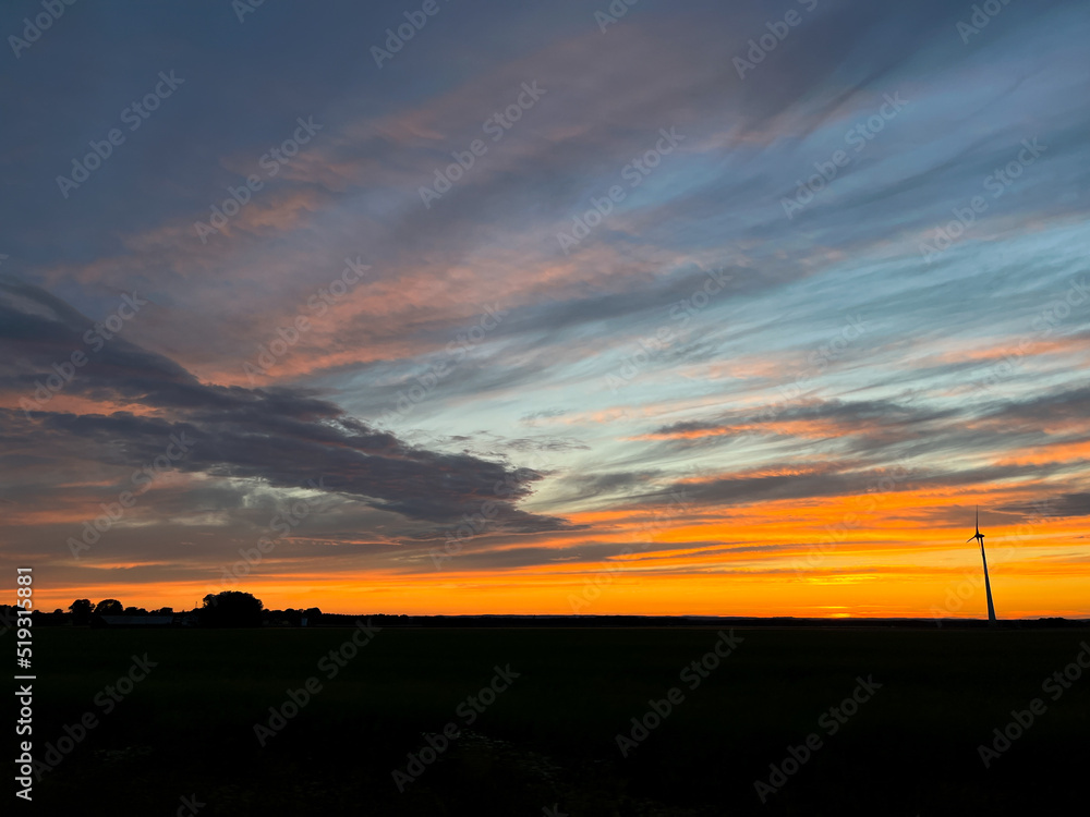 Orange sunset with purple cloud in the landscape, black silhouette of the landscape
