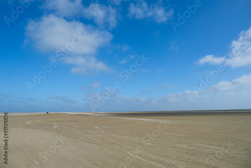 Empty sandy  beach on the north sea, windy weather © Oksana