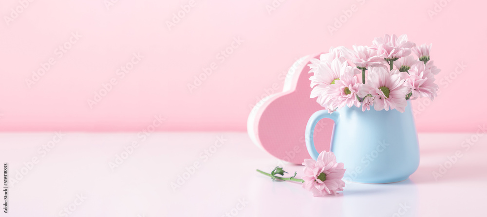 Pink flowers in blue cup against pink wall. Valentine's Day, Happy Woman's Day, Mother's Day, Birthday, Wedding Pink flowers in blue cup against pink wall. Valentine's Day, Happy Woman's Day, Mother's Day, Birthday, Wedding