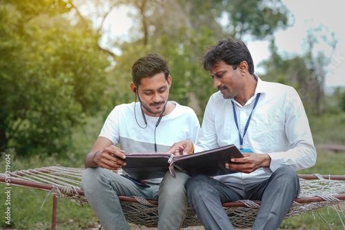 Quadro su tela India bank officer completing paper work with youngster at home