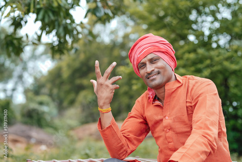 Indian farmer in traditional wear and giving happy expression at home