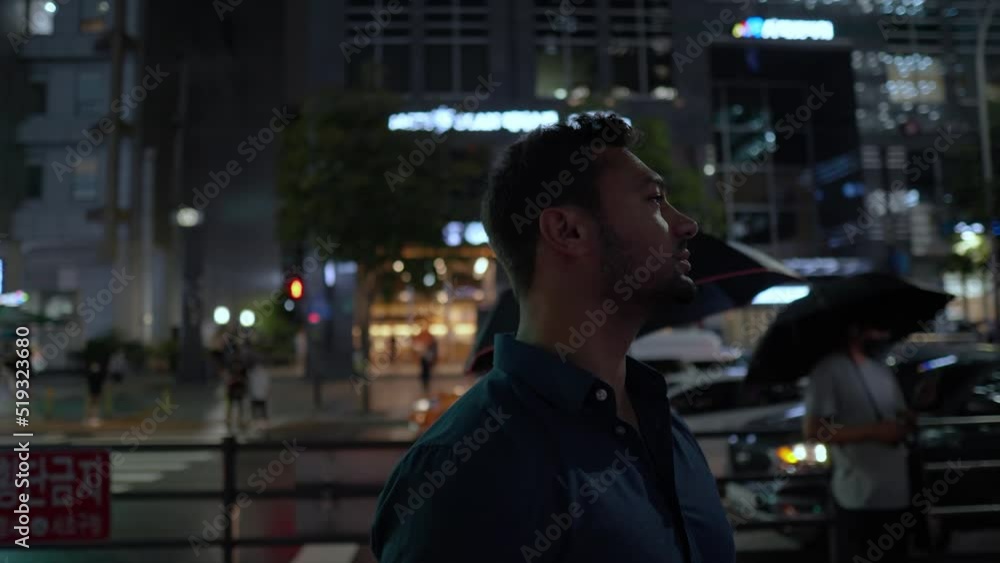 Portrait of tired exhausted young man waiting for bus at Gangnam Station at night Seoul in slow motion Portrait of tired exhausted young man waiting for bus at Gangnam Station at night Seoul in slow motion