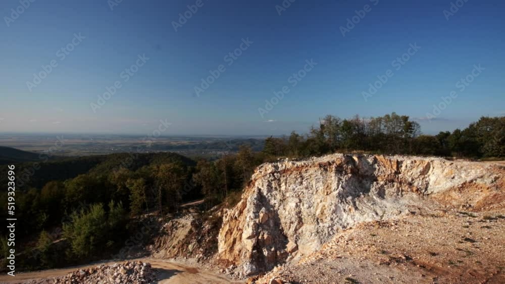 Romanian woman walks on the mountain and admires the stone quarry 1 Romanian woman walks on the mountain and admires the stone quarry 1