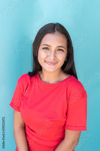 Latin American woman smiling in the street wearing casual clothes