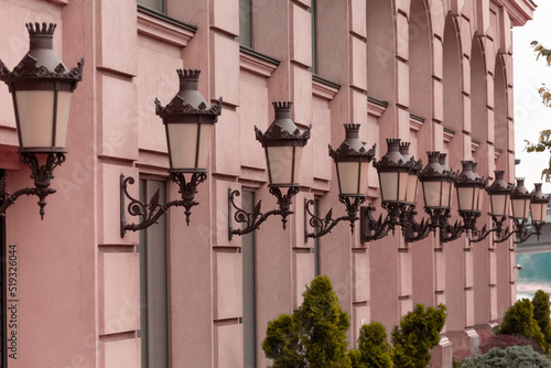 Vintage lanterns on old houses. Ancient houses in a European city.