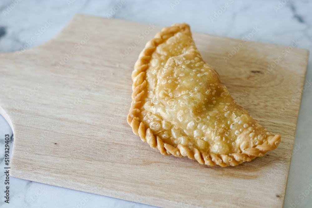 Cornish pasty filled with chicken and potato. Pastry minced pie or Pastel asian style cuisine. Homemade flaky pasty with mince meat filling - obrazy, fototapety, plakaty 
