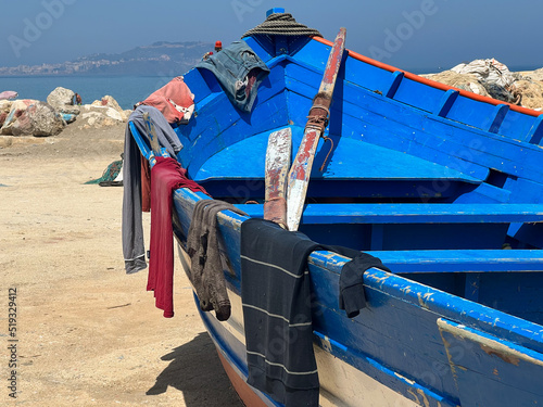 Laundry clothes hanging and drying on a fishing boat photo