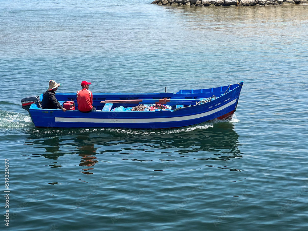Fishermen sailing on a motorboat on the mediterranean sea