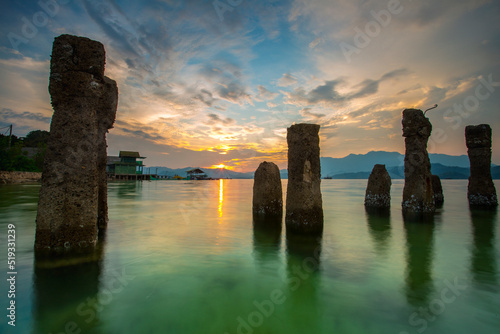 stunning sunset on the beach Tanjung Putus Lampung. building on a clear sea under a sunset. Indonesian landscapes tropical beaches