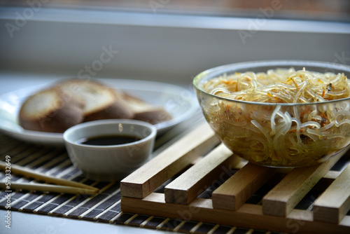 Korean rice noodles with meat and spices. Noodles with sauce and bread. Noodle sticks.