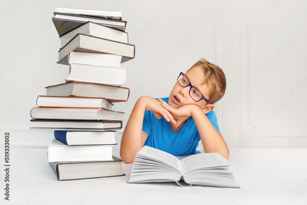 Surprised kid with many books trying to learn. Amount of educational material in school - concept. Surprised kid with many books trying to learn. Amount of educational material in school - concept.