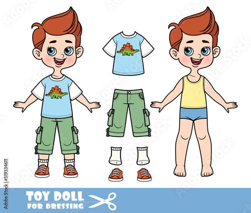 Cartoon boy with brunette hair dressed and clothes separately -T-shirt with stegosaurus, breeches with additional patch pockets and sneakers doll for dressing