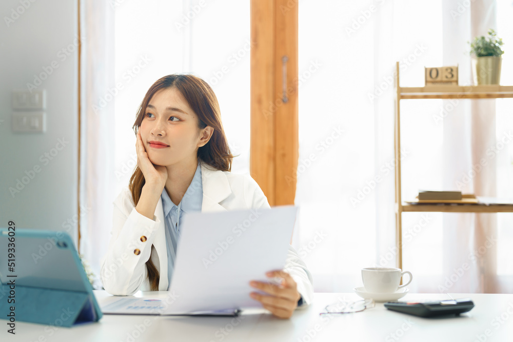 Successful business concept, Businesswoman hold financial document to thinking about new project Successful business concept, Businesswoman hold financial document to thinking about new project