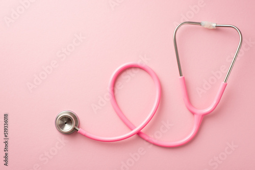 Breast cancer awareness concept. Top view photo of pink stethoscope on isolated pastel pink background photo