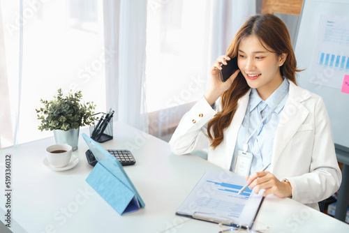 Wallpaper Mural Successful business concept, Businesswoman talking on smartphone and looking data on tablet Torontodigital.ca
