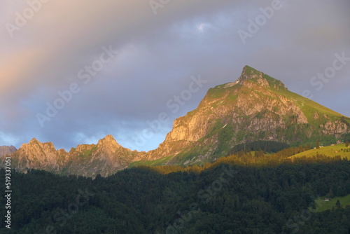 A majestic mountain called Fronalpstock in the Glarus Alps, illuminated by the evening sun