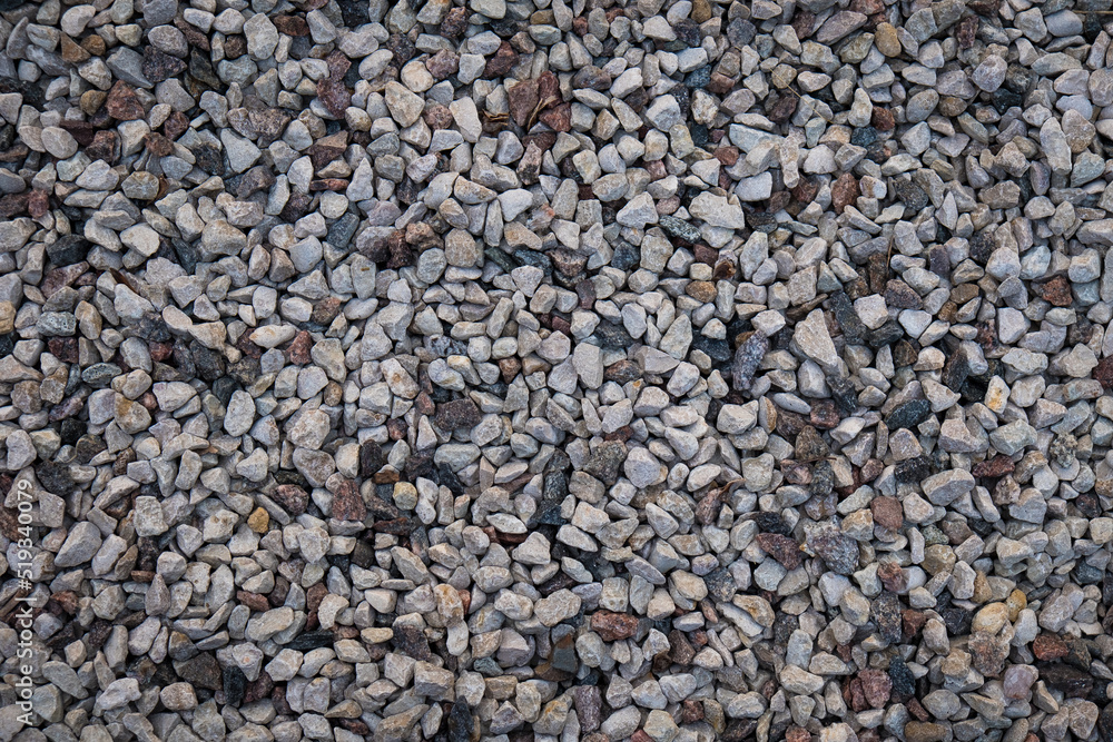 Mixed small gray broken rocks, loose gravel, road construction. Limestone aggregate. Crushed stone background Mixed small gray broken rocks, loose gravel, road construction. Limestone aggregate. Crushed stone background