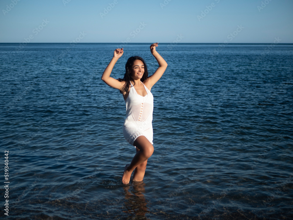 Happy young ethnic woman enjoying sunny day in sea Happy young ethnic woman enjoying sunny day in sea