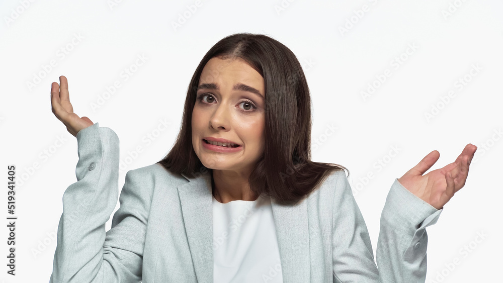 confused businesswoman in grey blazer showing shrug gesture isolated on white. confused businesswoman in grey blazer showing shrug gesture isolated on white.