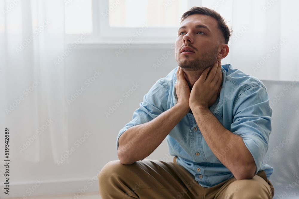Upset bored guy need professional psychology help have depression. Frustrated tired sad young handsome man touches neck looks up can not make important decision in life sitting at home. Emotions Upset bored guy need professional psychology help have depression. Frustrated tired sad young handsome man touches neck looks up can not make important decision in life sitting at home. Emotions