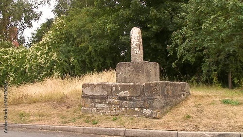 A burial mound also called a butter cross, a medieval construction in Barrow, a village in the county of Rutland, England photo