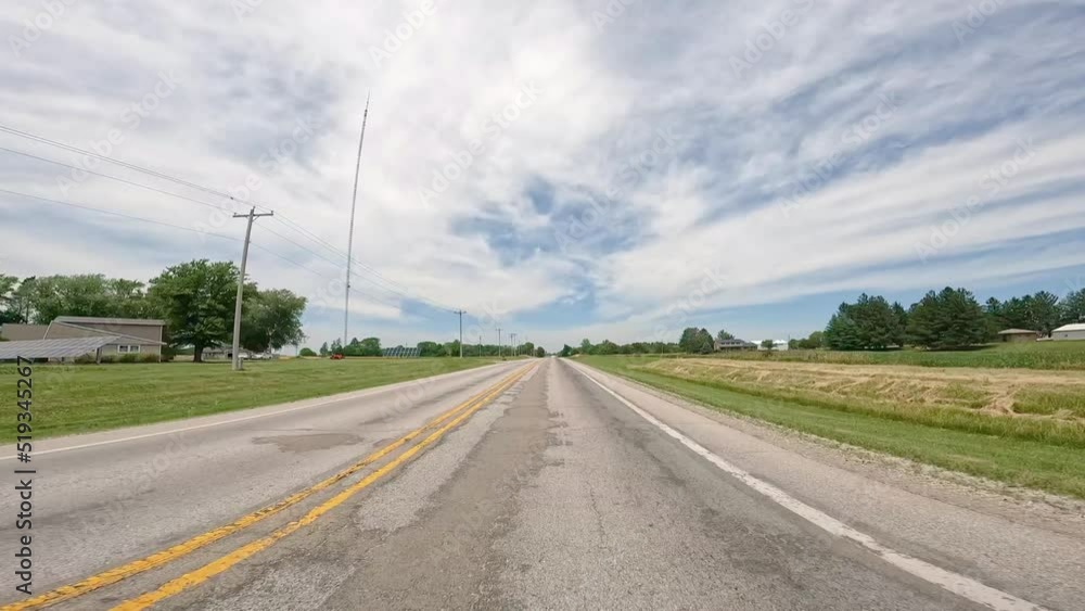 POV while driving on country road through rural Illinois; driving past homes, farms and solar panels; concepts of open road, rural life and transportation POV while driving on country road through rural Illinois; driving past homes, farms and solar panels; concepts of open road, rural life and transportation