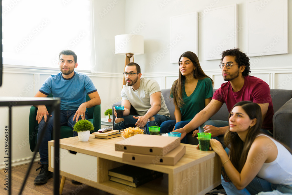 Friends sport fans enjoying a football game on tv