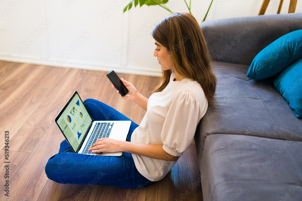 Hispanic woman doing home office in the living room Hispanic woman doing home office in the living room