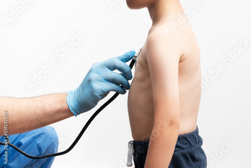 Close up picture of doctor examining a little bou with stethoskope. Boy went to rutinal doctor's check up. Health care concept.