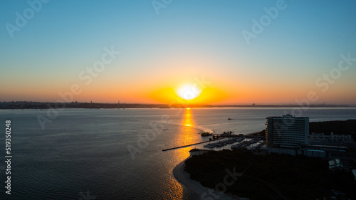 huge sunrise in Troia Peninsula, Setubal, Portugal on a sunny day, near Lisbon. over Sado river with setubal in the background