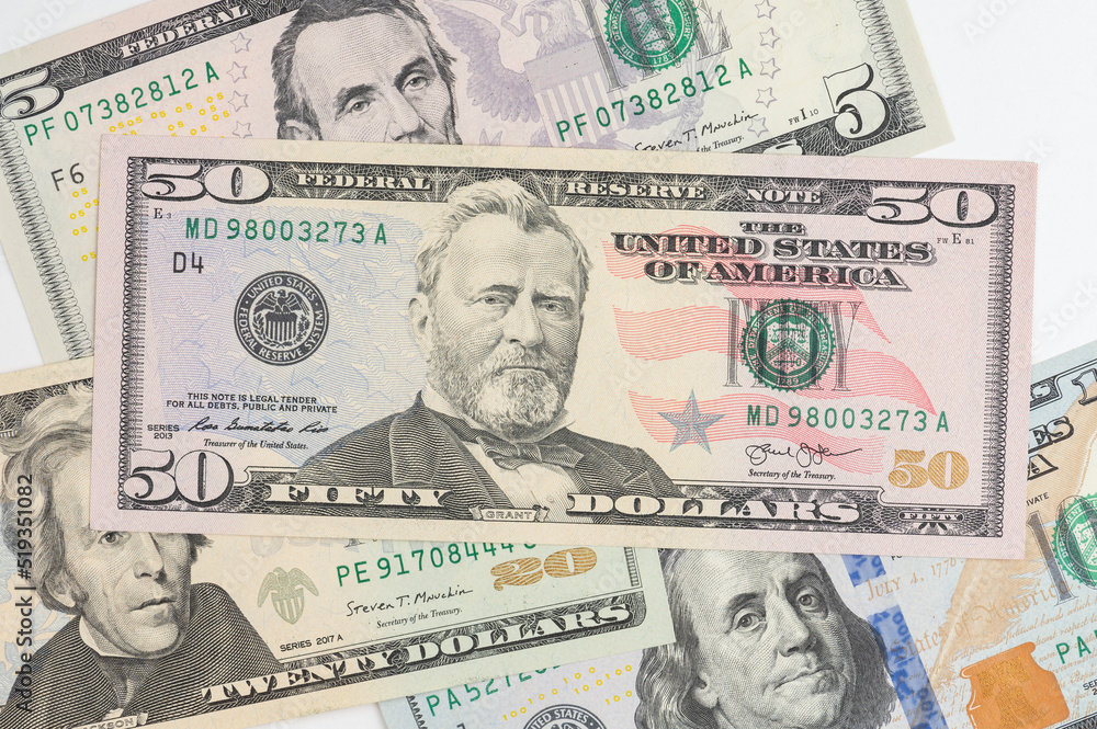 5, 20, 50, 100 dollars banknotes at different angles. Close up of dollars on white background.