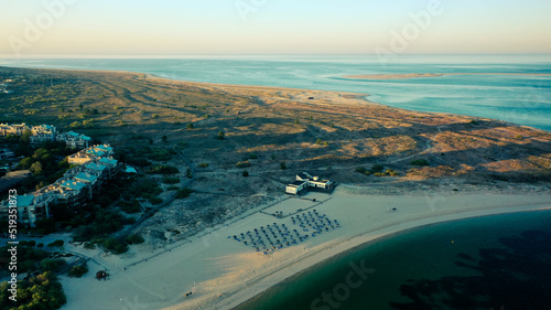 Aerial Bird's eye view of beach in Troia Peninsula on a huge sunrise, near Lisbon. ocean in the background