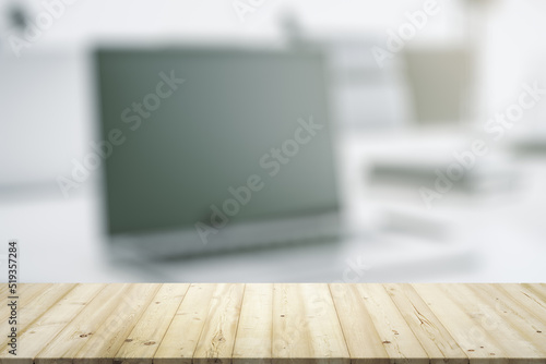 Empty office wooden desktop with empty space on modern workplace with laptop background, close up, mockup © Pixels Hunter