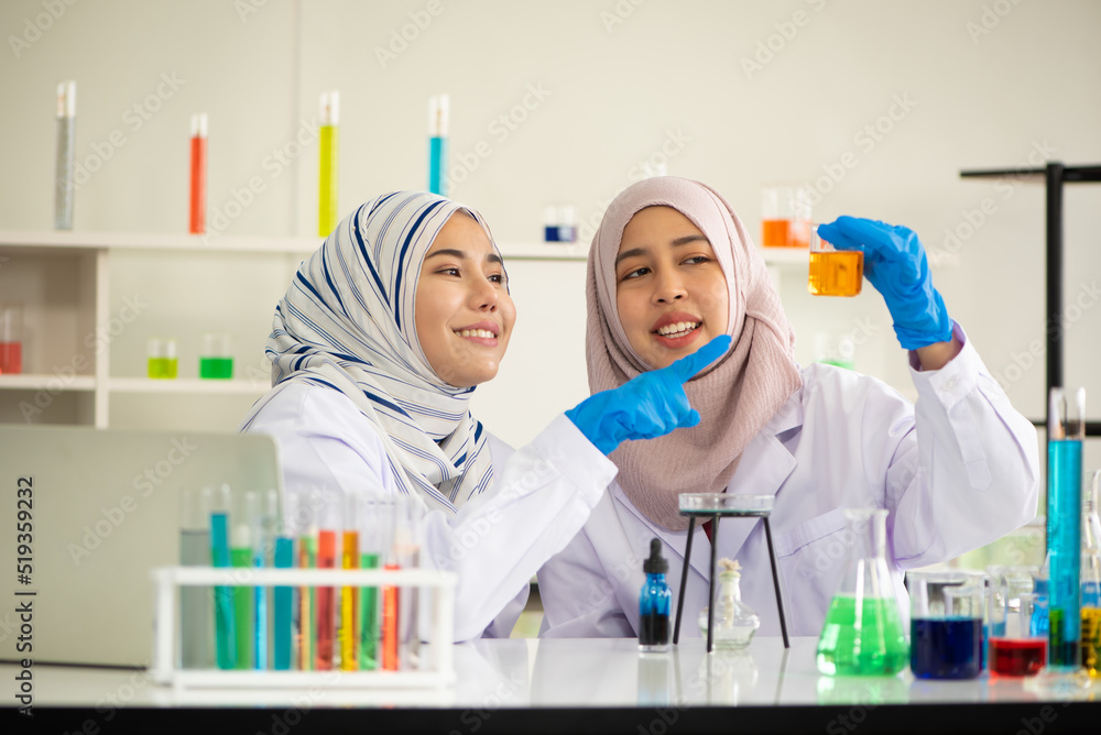 Professional Young Muslim Scientist Female Doing Experiments in Lab. Professional Young Muslim Scientist Female Doing Experiments in Lab.