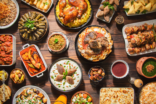 Arabic Cuisine: Middle Eastern traditional lunch. It's also Ramadan "Iftar". The meal eaten by Muslims after sunset during Ramadan. Assorted of Arabic oriental dishes. Top view with close up. 