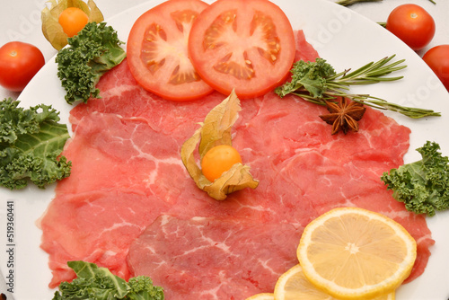 Carpaccio dish of thinly sliced pieces (slices) raw beef tenderloin 