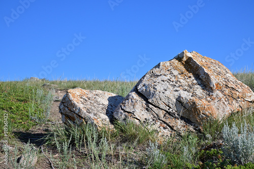  large split sandstone rock on prairie landscape photo