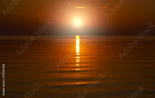 Beautiful orange sunset is reflected in the sea.