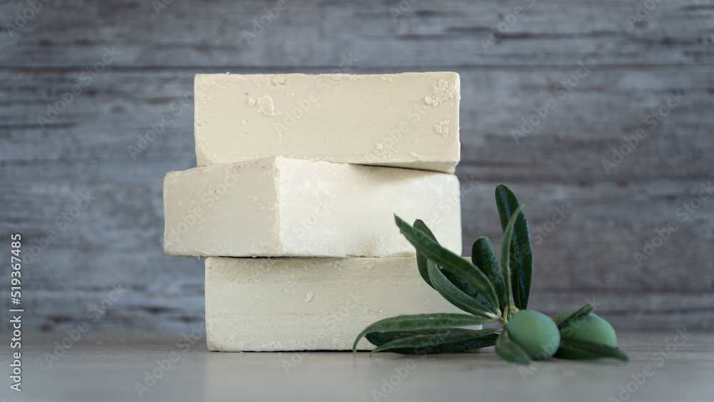 Natural Olive oil soap. Organic handmade soap bars with olive branch concept. Skin care products. Selective focus. Natural Olive oil soap. Organic handmade soap bars with olive branch concept. Skin care products. Selective focus.