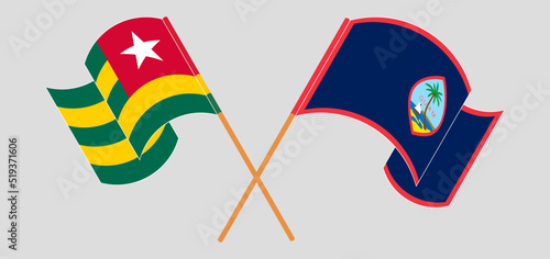 Crossed and waving flags of Togo and Guam