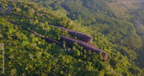 4K-Aerial video from flying drone over landscape with the Mountain in the morning sky at Three Whale Rocks the stone shaped like  whale,famous tourist attraction of Bueng Kan province amazing Thailand