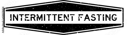 Grunge black intermittent fasting word hexagon rubber seal stamp on white background