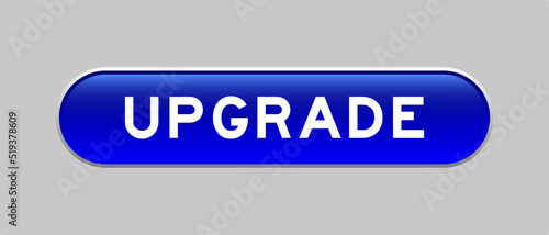 Blue color capsule shape button with word upgrade on gray background